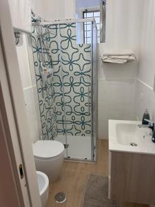 a bathroom with a shower with a toilet and a sink at B&B Ambra in Sarno