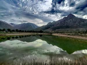 a body of water with mountains in the background at Tranquility - Cabin nestled in the mountains in Worcester