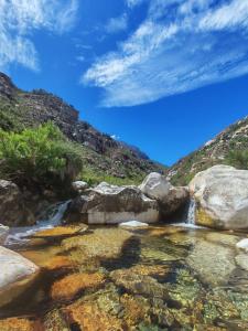 a creek in the mountains with rocks in the water at Tranquility - Cabin nestled in the mountains in Worcester