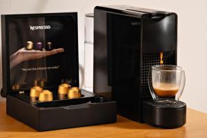 a coffee maker with a glass and a drink at Morfeas Hotel in Chania