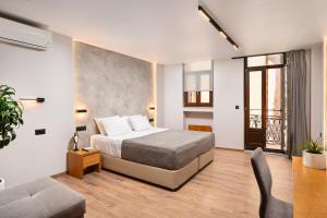 a hotel room with a bed and a couch at Morfeas Hotel in Chania