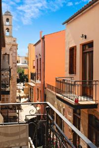 a view of an alley with buildings and a clock tower at Morfeas Hotel in Chania