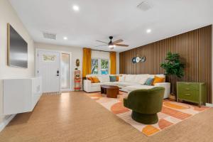 a living room with a white couch and a green chair at The Mimosa House in Sarasota