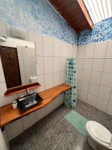 a bathroom with a sink and a mirror at L0st & Found House - Casa Bar in Puerto Iguazú +13 photos