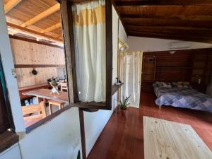 a small room with a bed and a window at L0st & Found House - Casa Bar in Puerto Iguazú