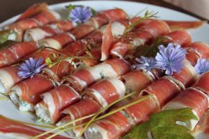 a plate with a bunch of bacon wrapped food at Les rives de Champagne in Courceroy