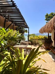 a resort with a view of the beach and the ocean at Panari Lodge El Nido in El Nido