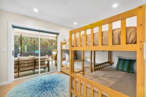 a bedroom with two bunk beds and a living room at The Mimosa House in Sarasota +34 photos