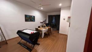 a room with a ping pong table and a dining room at Serene Private Villa Kangar in Kangar