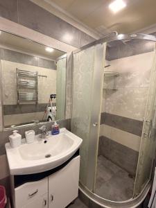 a bathroom with a sink and a shower at Comfortable zone in Yerevan +7 photos