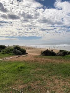 a group of people walking on the beach at Anza surf spot in Agadir +22 photos