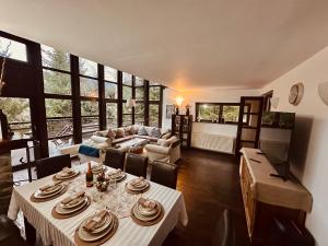 a living room with a table and a couch at Casa Ema Azuga in Azuga