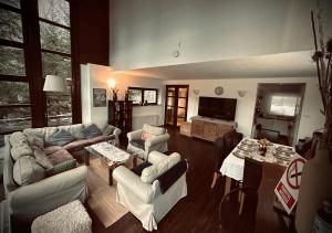 a living room with a couch and a table at Casa Ema Azuga in Azuga