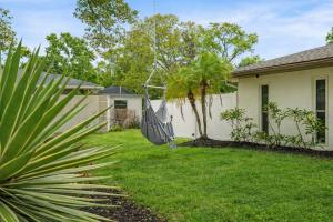 a yard with a swing in front of a house at The Mimosa House in Sarasota