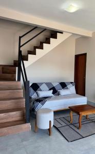 a bedroom with a bed and a stair case at Chácara Reserva do Cerrado in Cavalcante