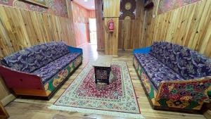 a living room with two couches and a table at Apartment in Thimphu