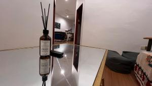 a bottle of wine sitting on top of a glass table at Serene Private Villa Kangar in Kangar