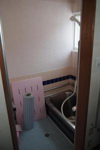 a bathroom with a sink and a box in the floor at Puffin House in Engaru +13 photos
