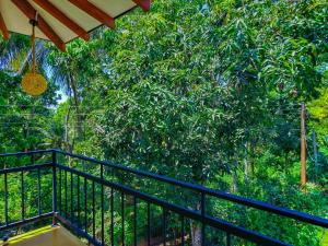 a balcony with a view of a tree at YK House Midigama in Midigama East