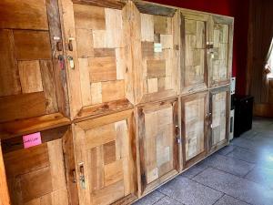 a group of wooden doors on a wall at Chakra Tavern in Bedugul