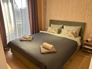 a bedroom with a large bed with towels on it at Красник Хілс in Krasnik +19 photos