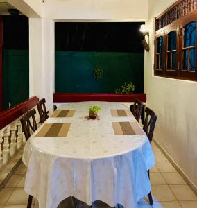 a dining room with a table and chairs at Bay Street in Beruwala