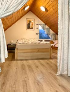 a bedroom with a bed in a attic at Domki Oaza Ciszy in Polańczyk