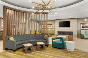 a living room with a couch and a tv at SpringHill Suites by Marriott Morgantown in Morgantown