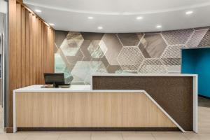 a lobby with a reception desk with a computer on it at SpringHill Suites by Marriott Morgantown in Morgantown