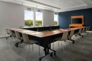a large conference room with a long table and chairs at Aloft by Marriott Richmond West Short Pump in Short Pump