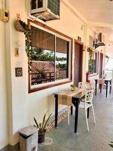 a dining room with a table and a window at Panari Lodge El Nido in El Nido +49 photos