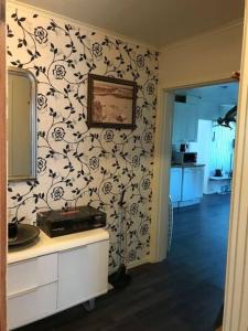 a kitchen with a wall with a black and white wallpaper at Workers Stay - Furnished Housing Umeå Sverige in Klabböle