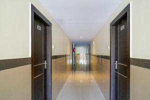 a hallway with doors open to a hallway with a hallway at Open Hotel by Olive - Hilvon Business Hotel in Bangalore