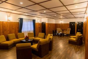 a waiting room with couches and chairs and a table at NAT CITY Hotel in Nuwara Eliya