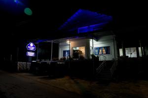 a gas station at night with a neon sign at NAT CITY Hotel in Nuwara Eliya