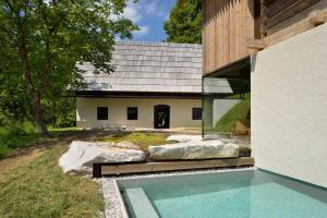 a house with a swimming pool in front of it at Alpine Contrapposto in Solčava