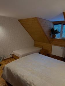 a bedroom with two beds and a window at DOM U Stefanów - Królowy Most in Królowy Most