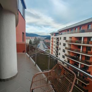a bench sitting on a balcony of a building at Magic Apartments 3 in Miercurea-Ciuc