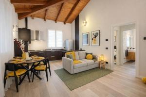 a living room with a couch and a table at Ca' Dei Coppi in Solignano Nuovo