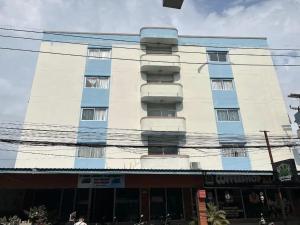 a tall white building with a lot of windows at Illusion Hostel & Club in Pattaya South
