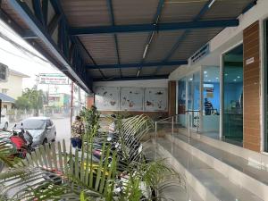 a store front with plants outside of a building at Illusion Hostel & Club in Pattaya South