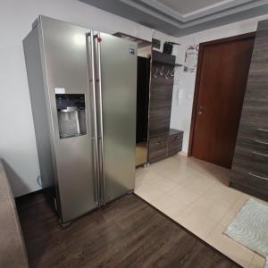 a kitchen with a stainless steel refrigerator in a room at Magic Apartments 3 in Miercurea-Ciuc