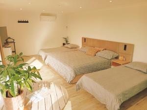 a bedroom with two beds and a potted plant at Il Giardino Segreto in Waterloo +50 photos