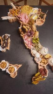 a table topped with lots of different types of food at Les champs dorés in Noyarey
