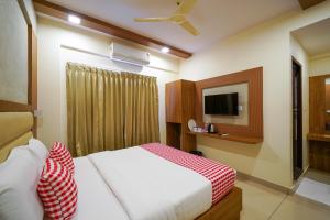 a hotel room with a bed and a tv at Open Hotel by Olive - Hilvon Business Hotel in Bangalore +20 photos