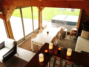a room with tables and chairs and a large window at Il Giardino Segreto in Waterloo