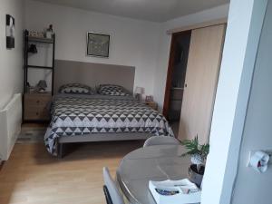 a bedroom with a bed and a table at Chambres d'Hôtes Arnold in Dambach-la-Ville
