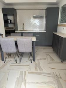 a kitchen with a table and chairs in a room at L'Opaline in Les Épesses