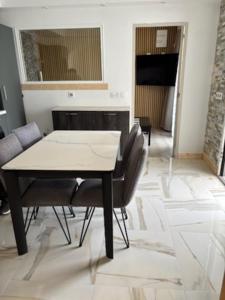 a dining room with a table and chairs in a room at L'Opaline in Les Épesses