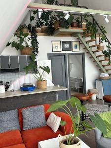 a living room with a couch and lots of plants at FiillhouseDilijan in Dilijan